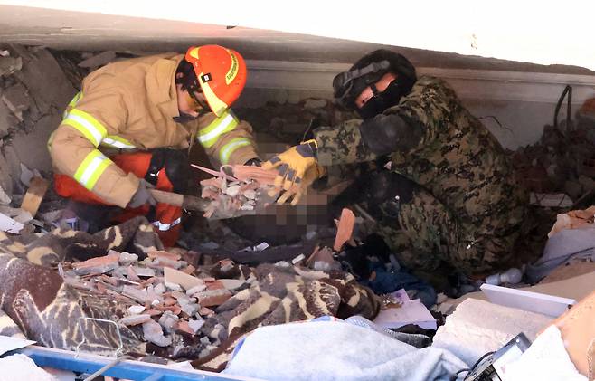 Members of the Korea Disaster Relief Team work to recover victims in the city of Antakya, Turkey, Friday. (Yonhap)