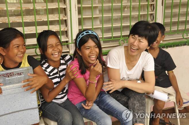 2013년 필리핀 임시 난민수용소 학교에서 아이들과 이야기하면서 웃는 한비야 [본인 제공]