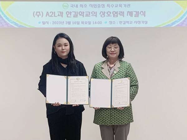 안경은(왼쪽) A2L 대표와 장은주 한길햑교 교장이 협약서를 들어보이고 있다.