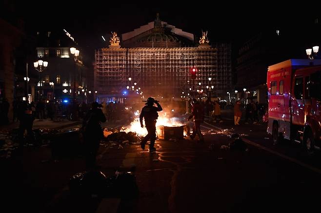 연금개혁에 항의하는 시위대가 20일(현지시간) 파리 오페라 광장 인근에서  쓰레기통에 붙인 불이 타오르고 있다./AFP연합뉴스