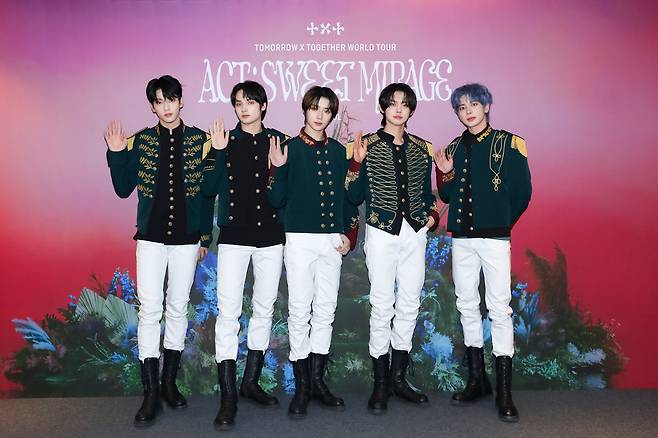 The Tomorrow X Together members pose for a picture during the press conference for their "Act: Sweet Mirage" world tour concerts held in the KSPO Dome in Olympic Park, Seoul, on Sunday. (Big Hit Music)