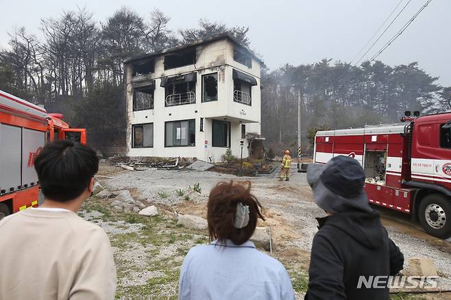 [강릉=뉴시스] 김경목 기자 = 11일 오후 강원 강릉시 사근진해변 뒤 안현동 펜션 여러 채가 불에 탄 가운데 피해 주민이 화재로 불에 탄 자신의 펜션을 바라보고 있다. 2023.04.11. photo31@newsis.com