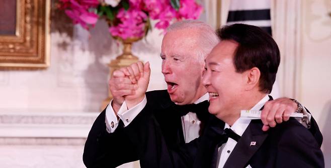 방미 성과보다 화려했던 의전 미국을 국빈방문 중인 윤석열 대통령이 26일 밤(현지시간) 백악관 이스트룸에서 열린 국빈만찬 도중 조 바이든 대통령과 손을 맞잡고 있다. 로이터연합뉴스