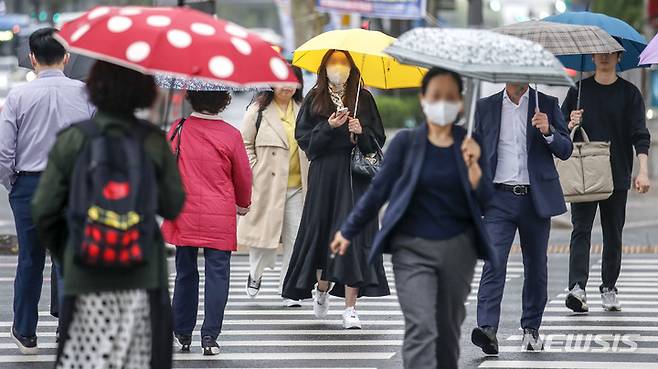 [서울=뉴시스] 정병혁 기자 = 지난 20일 오전 서울 종로구 광화문네거리에서 우산을 쓴 시민들이 이동하고 있다. 2023.04.20. jhope@newsis.com