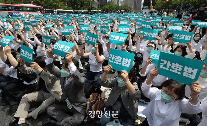 대한간호협회 회원들이 지난 12일 서울 종로구 세종대로 일대에서 열린 국제 간호사의 날 기념 축하한마당에서 간호법 제정을 촉구하며 손팻말을 들어보이고 있다. 조태형 기자