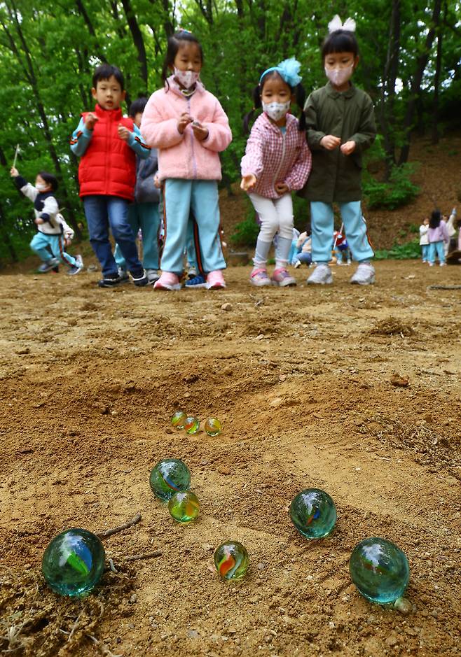 아해박물관을 찾은 어린이들이 구슬치기를 하며 즐거워하고 있다.