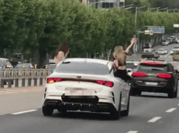 여성들은 창문을 통해 몸을 차량 밖으로 빼고 창문에 걸터앉는 위험천만한 행동을 서슴지 않았다. (사진=연합뉴스)
