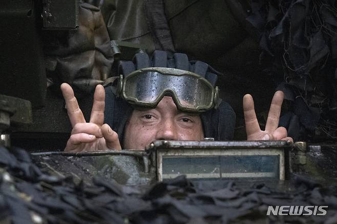 [바흐무트=AP/뉴시스] 지난 23일 우크라이나 바흐무트 인근 전선에서 한 전차병이 전차 밖을 내다보며 승리의 V 신호를 보내고 있다. 2023.05.26.