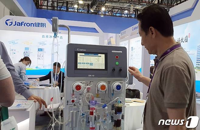 15일 중국 상해 국가회전중심(국제컨벤션센터)에서는 의료기기 전시회 '2023 CMEF'가 열렸다. 이승근 충북수의사회 회장이 혈액투석기를 살펴보고 있다. ⓒ 뉴스1 최서윤 기자