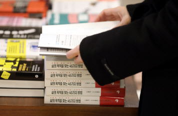 서울의 한 대형서점에서 인공지능 챗GPT가 쓴 자기계발서 ‘삶의 목적을 찾는 45가지 방법’을 방문객이 살펴보고 있다. 이 책은 챗GPT가 집필하고, 번역은 AI 파파고가, 인간은 기획, 인쇄, 출판을 담당했다(사진=뉴시스).