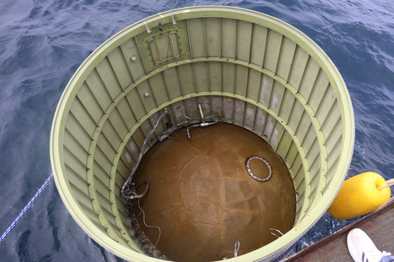 A photo of the the white metal cylinder that is believed to have been part of the North Korean satellite launch vehicle that crash into the sea on Wednesdy. [JOINT CHIEFS OF STAFF]