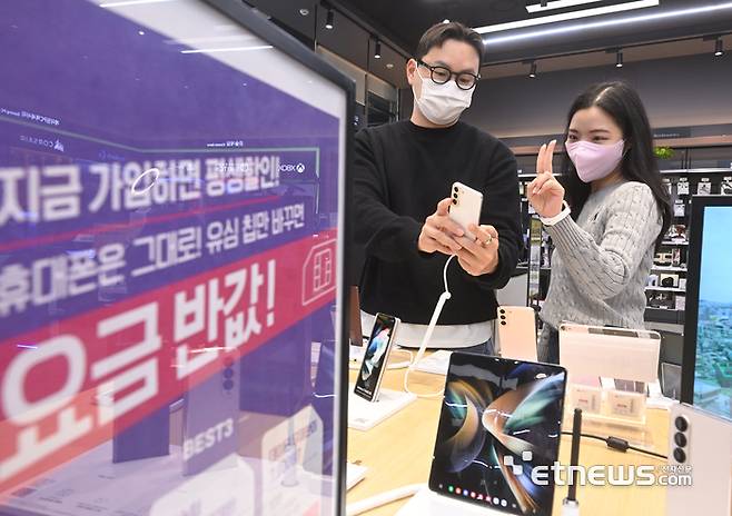 롯데하이마트 대치점에서 시민들이 알뜰폰을 보고 있다.