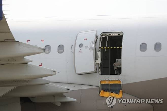 지난달 26일 대구국제공항에 착륙한 아시아나 비행기의 비상구가 비상개폐되며 파손된 모습을 보이고 있다. 연합뉴스