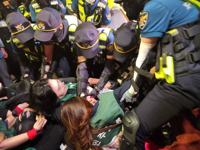 9일 밤 9시50분께 비정규직 이제그만 공동투쟁이 주최한 ‘2차 노숙문화제’ 참가자들이 경찰에 의해 끌려나가고 있다. 고병찬 기자