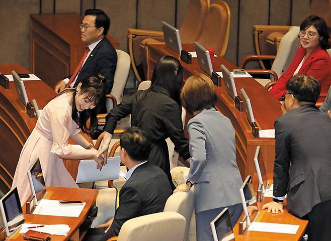 국민의힘 김예지(맨 왼쪽) 의원이 14일 국회 본회의장에서 열린 대정부질문에서 발언을 마치고 동료 의원들의 격려를 받으며 이동하고 있다. /뉴시스