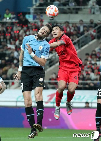 대한민국 축구 국가대표팀 김민재가 28일 오후 서울 마포구 서울월드컵경기장에서 열린 축구 국가대표 평가전 대한민국과 우루과이의 경기에서 상대 선수와 헤딩 경합을 벌이고 있다. 2023.3.28/뉴스1 ⓒ News1 민경석 기자