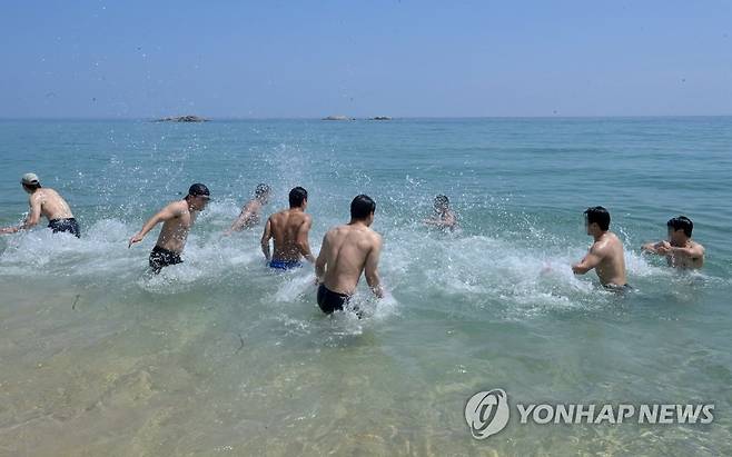 강원 강릉시 경포해수욕장을 찾은 젊은이들이 시원한 바다에 뛰어들어 무더위를 식히고 있다. [연합뉴스 자료사진]