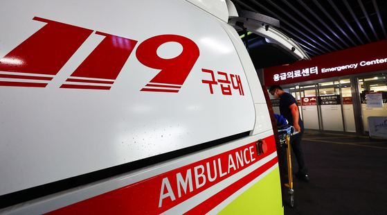 Ambulance operators moving an incoming patient to the emergency room of Ewha Womans University Seoul Hospital in western Seoul on June 10.