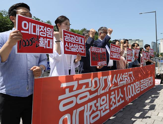 25일 오전 서울 용산구 대통령실 인근에서 경제정의실천시민연합 관계자들이 공공의대 신설과 의대 정원 확대를 요구하는 기자회견을 열고 구호를 외치고 있다. [연합]