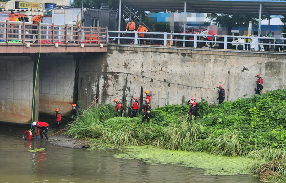 An emergency rescue team on Wednesday search for a woman in her 60s that went missing in Busan a day before after heavy rain with maximum precipitation of 68 millimeters (2.6 inches) per hour fell on the city. [BUSAN METROPOLITAN CITY FIRE & DISASTER HEADQUARTERS]