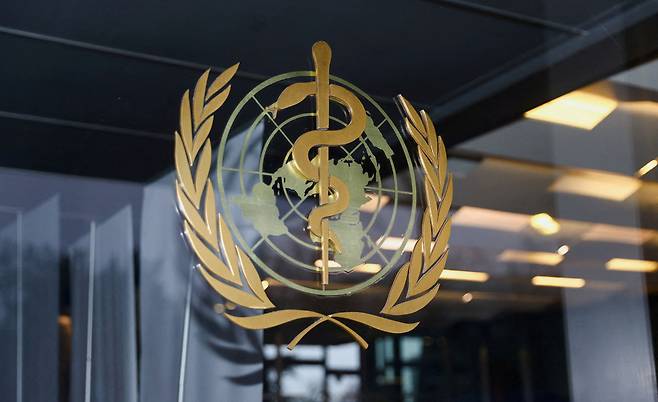 FILE PHOTO: The World Health Organization logo is pictured at the entrance of the WHO building, in Geneva, Switzerland, December 20, 2021. REUTERS/Denis Balibouse/File Photo