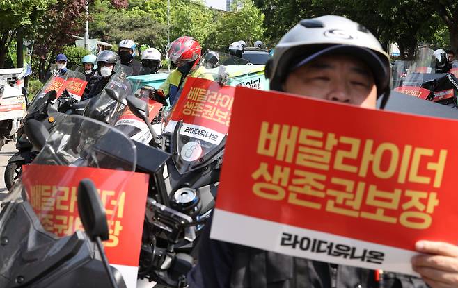 10일 오후 여의도 산업은행 인근에서 민주노총 공공운수노조 라이더유니온 관계자들이 처우 개선을 요구하며 구호를 외치고 있다. [연합]