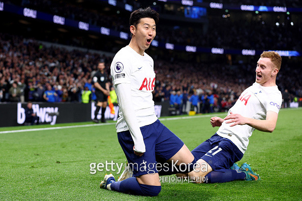 LONDON, ENGLAND - MAY 12: Heung-Min Son of Tottenham Hotspur celebrates with Dejan Kulusevski after scoring their side's third goal during the Premier League match between Tottenham Hotspur and Arsenal at Tottenham Hotspur Stadium on May 12, 2022 in London, England. (Photo by Clive Rose/Getty Images)