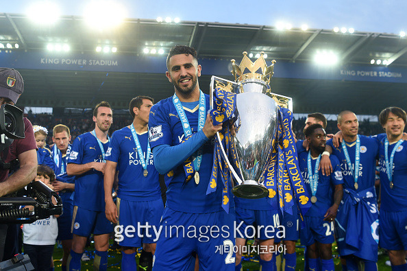 LEICESTER, ENGLAND - MAY 07: Riyad Mahrez of Leicester City poses with the Premier League Trophy as players and staffs celebrate the season champion after the Barclays Premier League match between Leicester City and Everton at The King Power Stadium on May 7, 2016 in Leicester, United Kingdom. (Photo by Michael Regan/Getty Images)