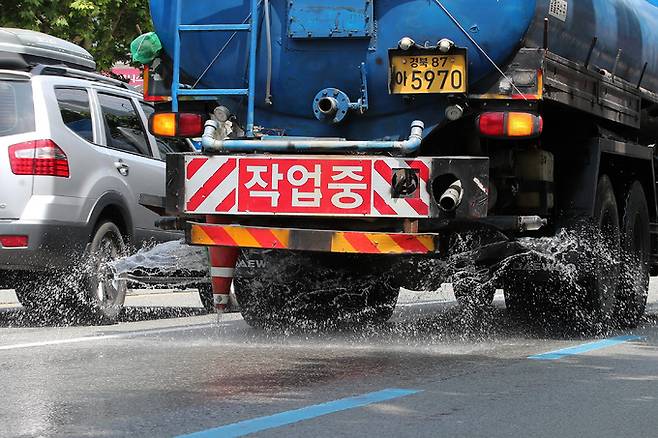 폭염이 이어진 31일 대구 도심에서 구청 살수차가 물을 뿌리며 뜨거워진 도로 열기를 식히고 있다. 뉴스1