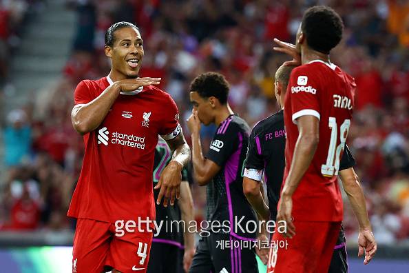 SINGAPORE, SINGAPORE - AUGUST 02: Virgil van Dijk #4 (L) of Liverpool celebrates with Cody Gakpo #18 after scoring their second goal off a header against Bayern Munich during the first half of the pre-season friendly at the National Stadium on August 02, 2023 in Singapore. (Photo by Yong Teck Lim/Getty Images)