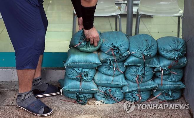 '태풍 대비' 모래주머니 쌓는 주민 (창원=연합뉴스) 정종호 기자 = 제6호 태풍 '카눈'이 북상 중인 9일 경남 창원시 마산합포구 월영동 어느 상가 앞에서 한 주민이 침수 피해 대비용 모래주머니를 쌓고 있다. 2023.8.9
