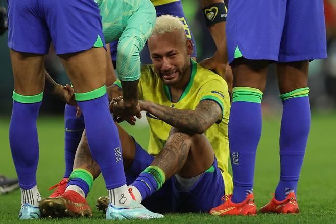 (FILES) Brazil's forward #10 Neymar reacts after his team lost the Qatar 2022 World Cup quarter-final football match between Croatia and Brazil at Education City Stadium in Al-Rayyan, west of Doha, on December 9, 2022. The memory of Ronaldo or Marta in a World Cup final is becoming more and more distant and diffuse. Brazil's power in football's top tournament is fading, and with it the hegemony of the land of the 'jogo bonito' is disappearing. (Photo by Adrian DENNIS / AFP)