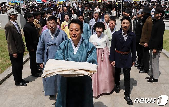 오세훈 서울시장이 15일 서울 종로구 보신각에서 열린 제78주년 광복절 기념 타종행사에서 태극기를 들고 타종을 위해 보신각으로 향하고 있다. 2023.8.15/뉴스1 ⓒ News1 박세연 기자