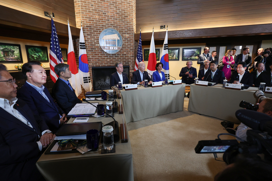 Korean President Yoon Suk Yeol, left, takes part in a trilateral summit with the U.S. and Japanese leaders at Camp David near Thurmont, Maryland, Thursday. [JOINT PRESS CORPS]