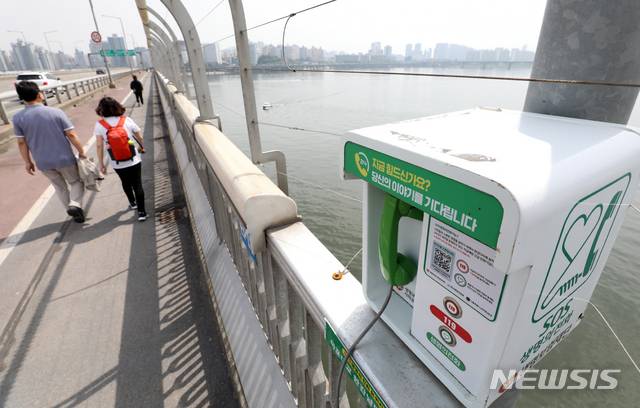 [서울=뉴시스]조성우 기자 = 23일 오전 서울 마포대교 안전 펜스에 설치된 SOS생명의 전화가 보이고 있다. 장력 센서가 설치된 펜스는 철사를 끊거나 10cm 이상 벌어지면 119구조대가 바로 출동한다. 2021.05.23. xconfind@newsis.com