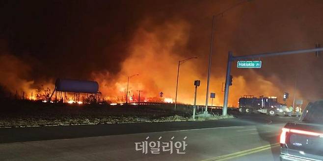 미국 하와이 마우이의 호키오키오 플레이스와 라하이나 사이 도로에서 불길이 치솟고 있다. ⓒAP/뉴시스