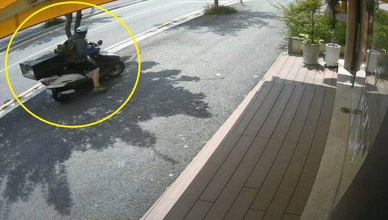 지난 18일 대전 서구 관저동에서 발생한 신협 현금강도 사건 용의자가 17일 대전 유성구의 한 인도에 놓인 오토바이를 훔쳐 달아나고 있다. [사진 독자]