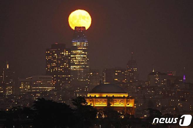 30일(현지시간) 미국 샌프란시스코에 위치한 스카이라인 뒤로 슈퍼 블루문이 떠 올라 있다. ⓒ AFP=뉴스1 ⓒ News1 이재명 기자