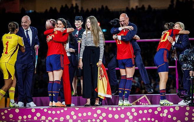 FILE PHOTO: Soccer Football - Spanish Soccer Federation Official Statement - Stadium Australia, Sydney, Australia - August 20, 2023 Spain's Jennifer Hermoso celebrates with President of the Royal Spanish Football Federation Luis Rubiales after the Women World Cup final match. This picture was released on August 25 by the Spanish Soccer Federation in Las Rozas, Spain to support their official statement regarding the hug that occurred before the kiss RFEF/Handout via REUTERS  ATTENTION EDITORS - THIS IMAGE HAS BEEN SUPPLIED BY A THIRD PARTY. NO RESALES. NO ARCHIVES  THIS IMAGE HAS BEEN SUPPLIED BY A THIRD PARTY./File Photo