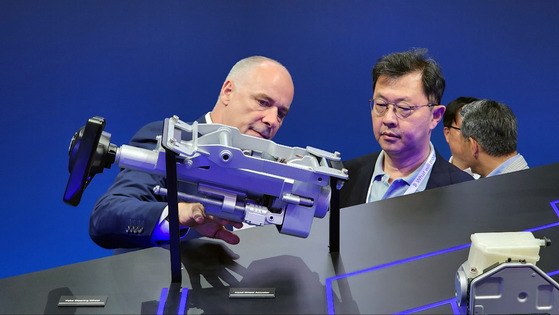 SK Group Executive Vice Chairman Chey Jae-won, SK On co-CEO, listens to a Volkswagen official explain about the ZF at the IAA 2023, Europe's largest mobility trade show, held in Munich, Germany, on Monday. [SK ON]