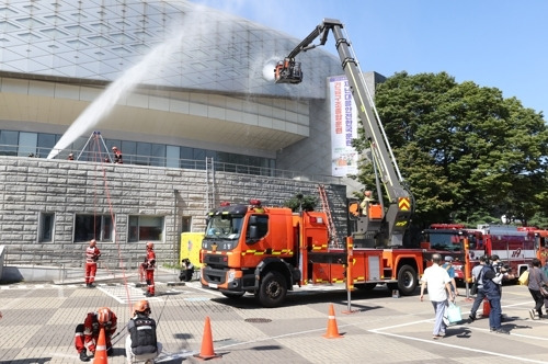 소방관들이 7일 송파구 올림픽공원에서 열린 ‘재난대응 안전한국훈련’에서 화재를 진압하고 있다. 서울시와 송파구가 주관한 이 훈련은 인파 밀집 사고 상황에 대비해 실시됐다. 연합뉴스