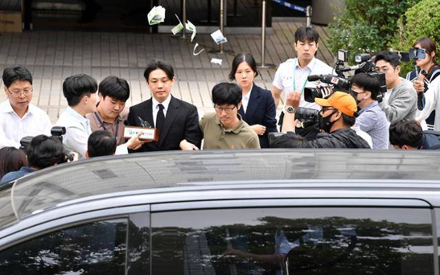 마약 상습 투약 혐의를 받는 배우 유아인(본명 엄홍식)이 21일 서울 서초구 서울중앙지방법원에서 열린 구속 전 피의자심문(영장실질심사)을 마치고 돌어가던 중 현장에 있던 유튜버가 "영치금으로 사용하라"고 유씨에게 돈다발을 던지고 있다. 김예원 인턴기자