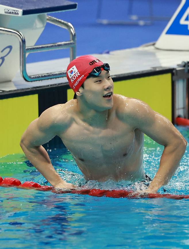 지유찬이 25일 중국 항저우 올림픽 스포츠센터 수영장에서 열린 2022 항저우 아시안게임 남자 자유형 50ｍ 예선에서 결승점을 터치한 뒤 수영장을 나서며 기록을 확인하고 있다. 지유찬은 21초 84로 대회 신기록을 작성했다. /연합뉴스
