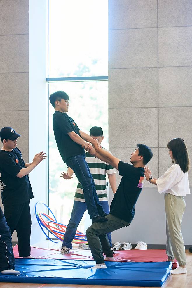 Participants try out hand-to-hand acrobatics during a "Circus Playground" workshop. (LG Arts Center)