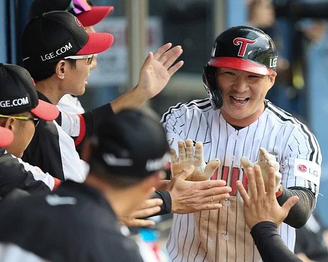 27일 프로야구 잠실 연속경기 1차전에서 득점 후 더그아웃으로 돌아와 축하받는 오지환. LG 제공