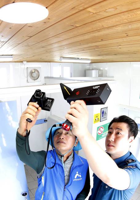 지난 6월7일 광주 북구 본촌동 한 어린이공원 공중화장실에서 구청 기후환경과 공무원과 북부경찰서 순찰대원들이 불법촬영 카메라 탐지기를 이용해 합동점검을 실시하고 있다. 연합뉴스