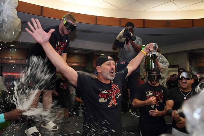 Sep 30, 2023; Phoenix, Arizona, USA; Arizona Diamondbacks manager Torey Lovullo (17) celebrates after after clinching a National League wild card spot during their game against the Houston Astros at Chase Field. Mandatory Credit: Joe Camporeale-USA TODAY Sports