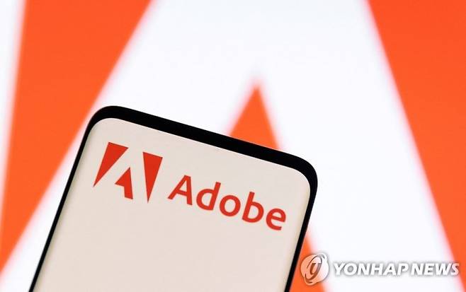 FILE PHOTO: Adobe logo is seen on smartphone in this illustration taken June 13, 2022. REUTERS/Dado Ruvic/Illustration/File Photo