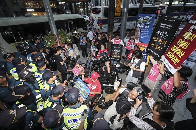 전국장애인차별철폐연대 회원들이 지난달 18일 오후 서울 중구 서울장애인고용공단 앞에서 경찰과 충돌하고 있다. 뉴시스