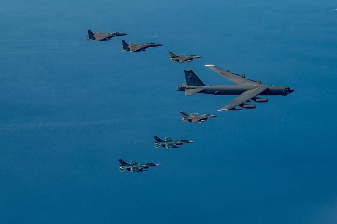 The US Air Force's nuclear-capable B-52 heavy bomber conducts a formation flight while being escorted by fighter jets from South Korea, the US, and Japan during a first-ever trilateral air exercise on Sunday south of the Korean Peninsula. (United States Air Force)